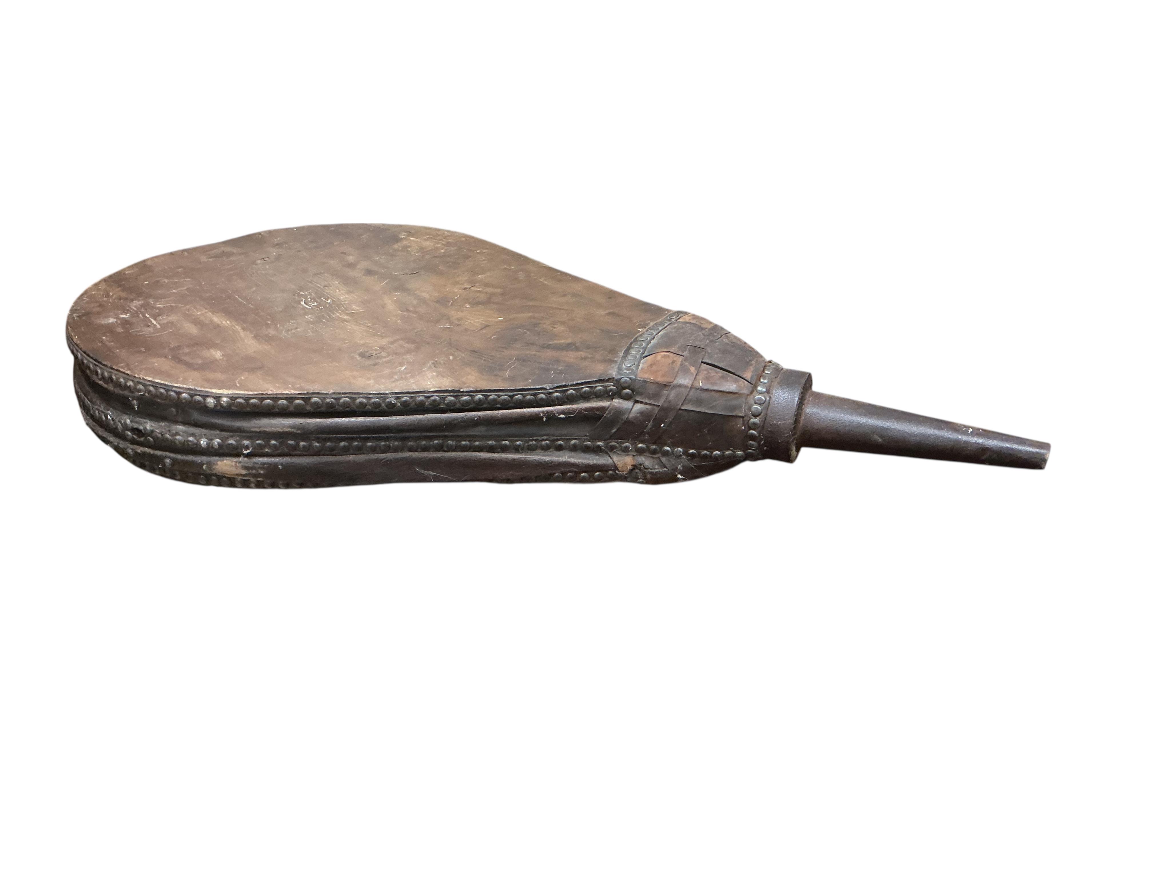 A set of 19th century iron and leather mounted oak blacksmith's bellows, now as a coffee table on twin barrel supports, width 63cm, depth 80cm, height 59cm